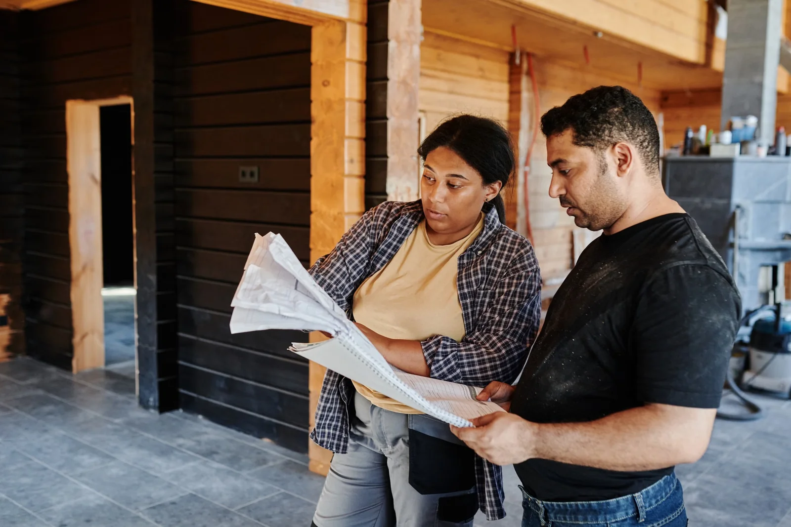 Construction professionals reviewing plans in a timber building