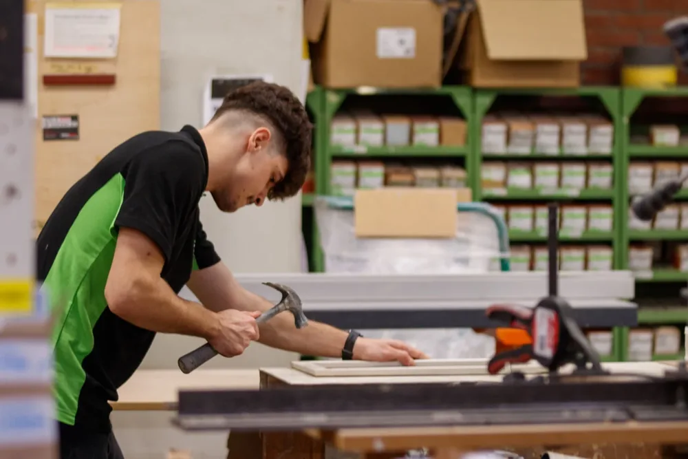 Young man working on a carpentry project in a workshop