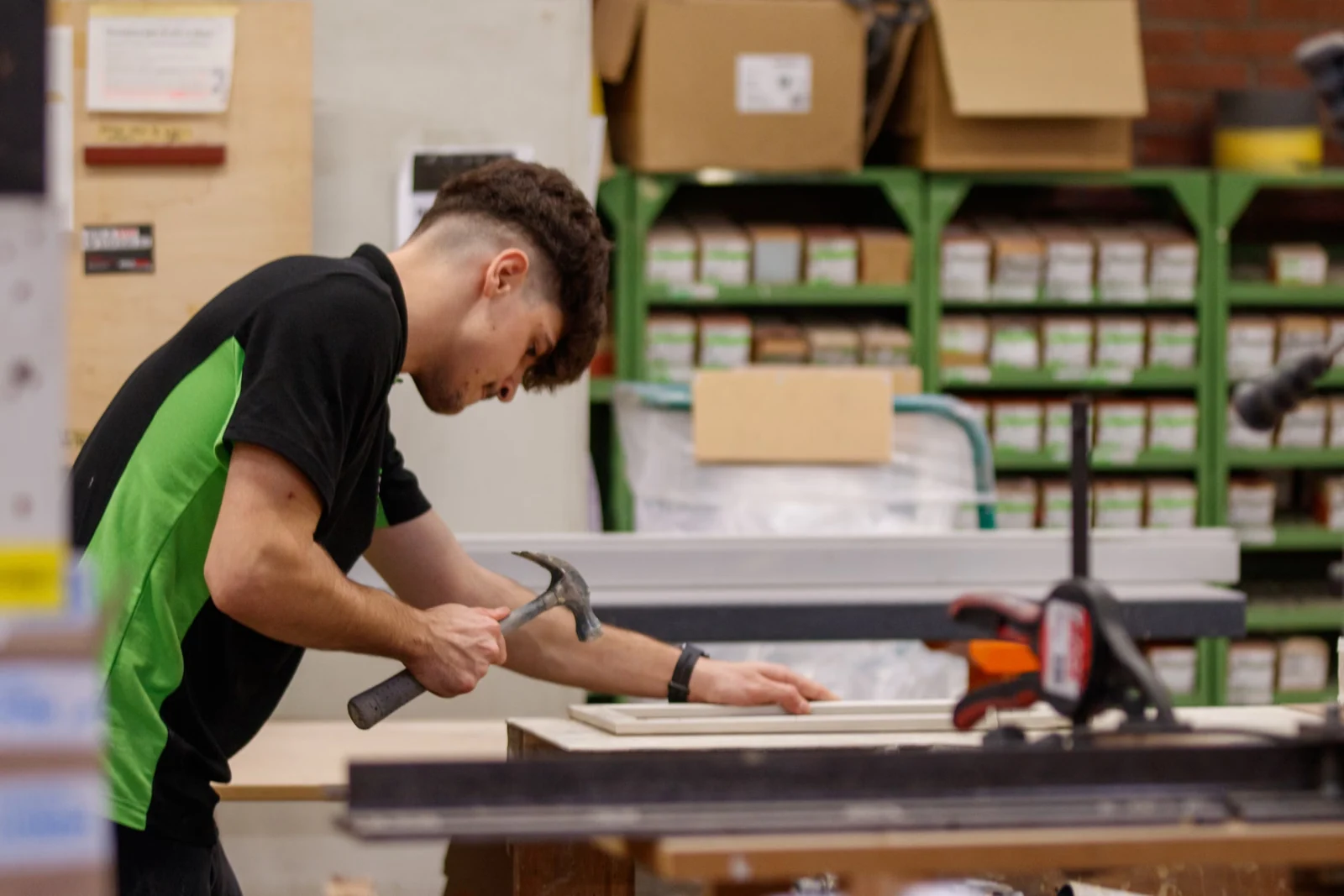 Young man working on a carpentry project in a workshop
