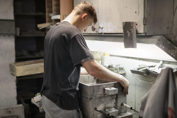 Young worker developing metalworking skills in a workshop