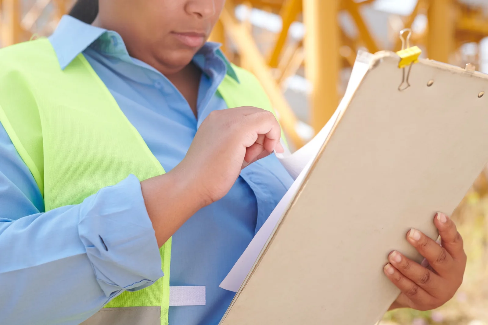 Construction professional reviewing documents on site