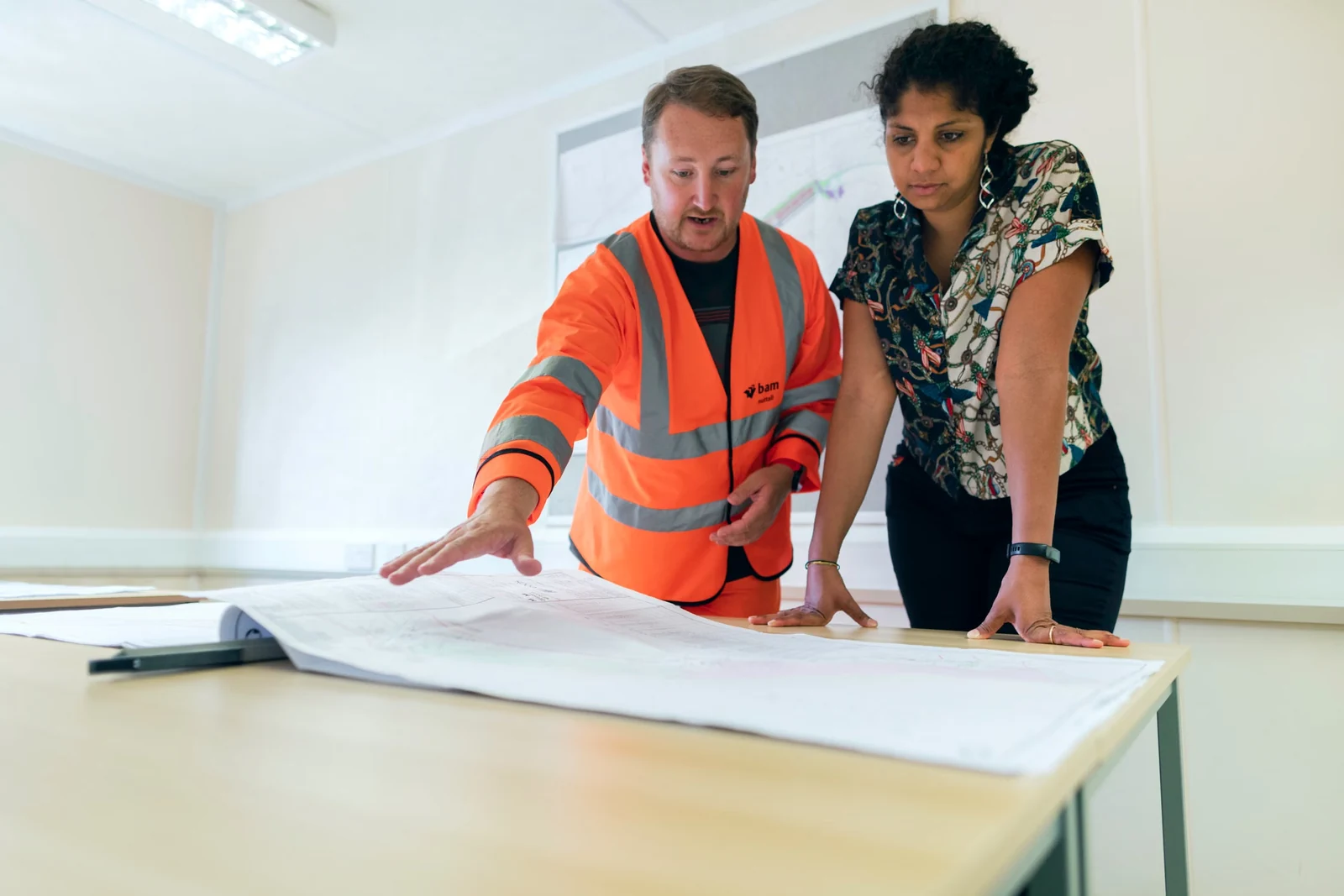 Two engineers reviewing plans together